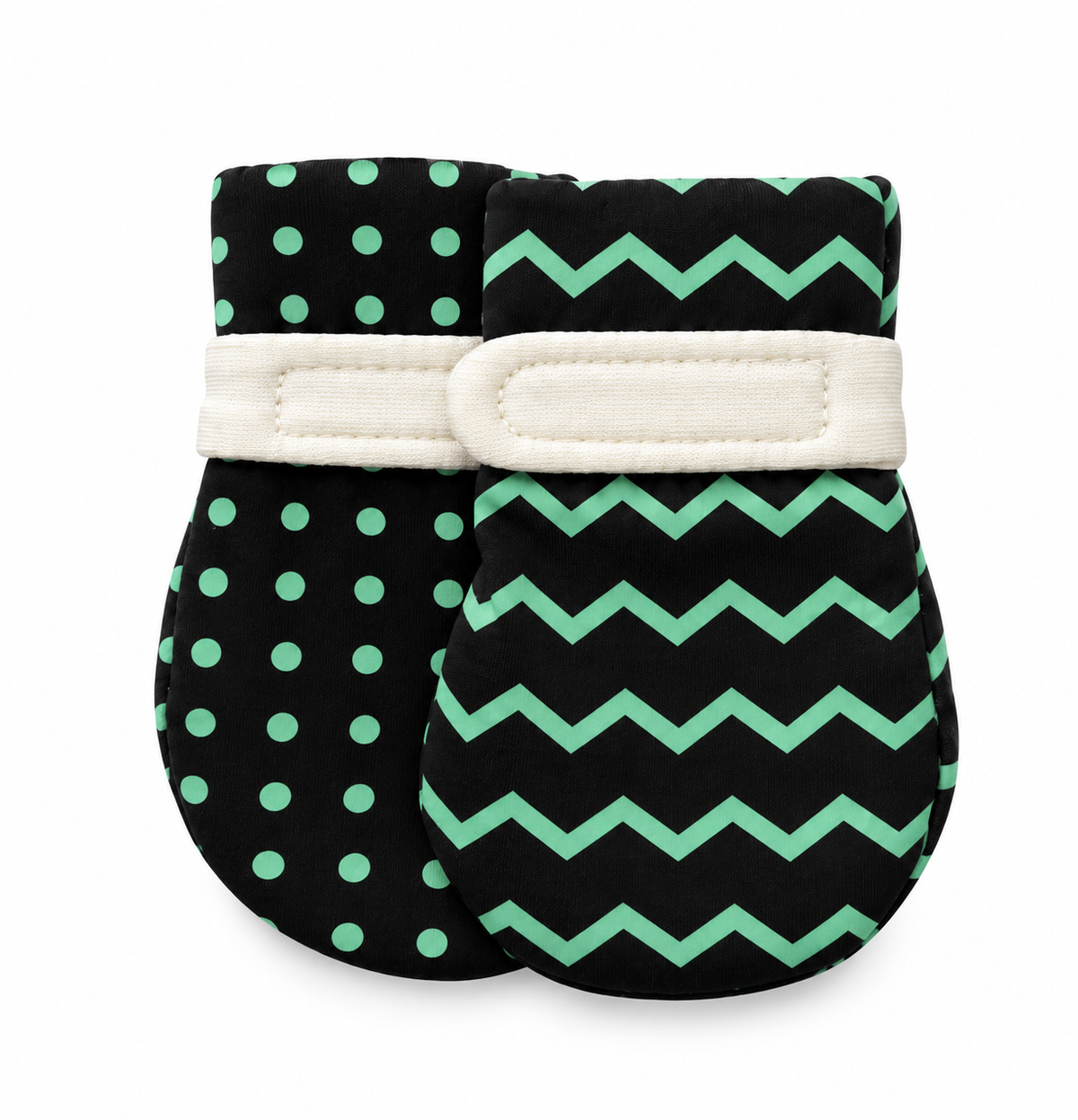 A pair of baby mittens, one featuring mint green polka dots and the other featuring a mint green chevron pattern to encourage visual development and hand discovery. both with a cream fabric strap.